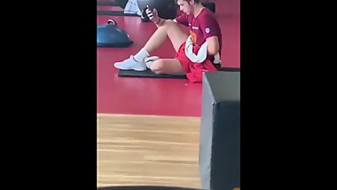 Young man masturbating at the gym